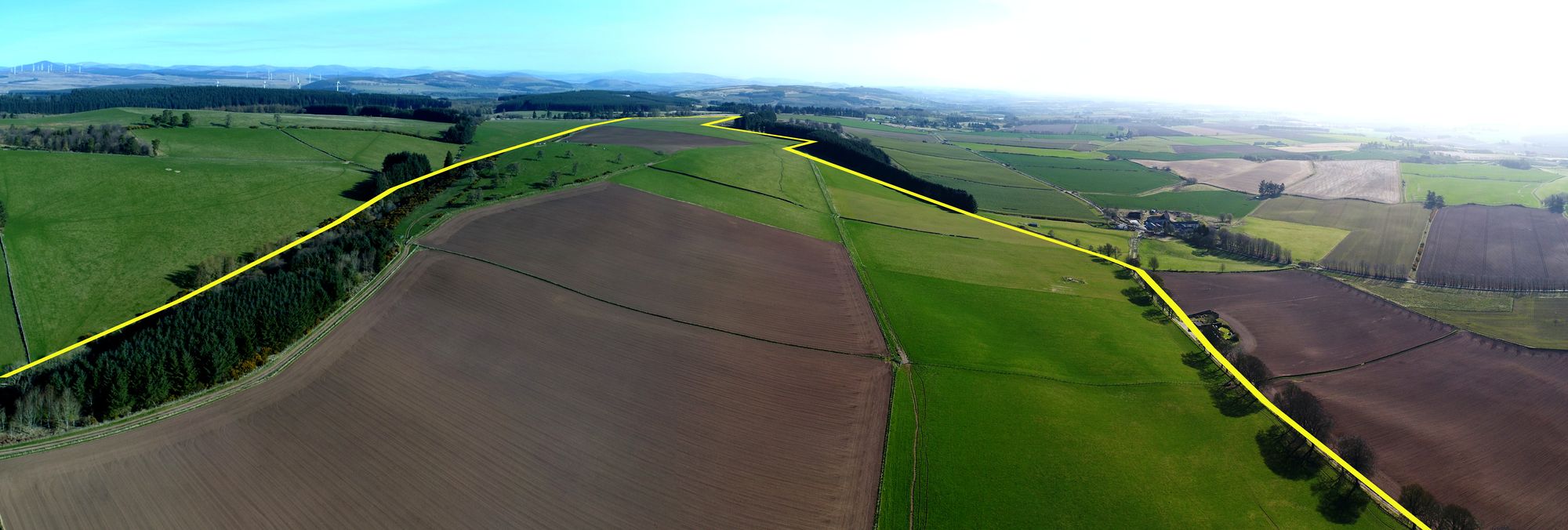 Aerial panorama with the land boundary drawn as a yellow line